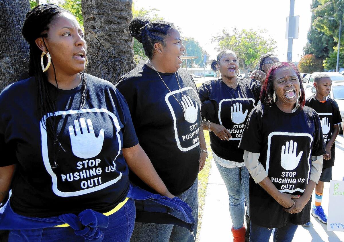 Fredrika Hammick, left, Ayesha Brooks, Tyronda Farley, and Keshia Wilson take part in a protest at Markham Middle School in South Los Angeles.