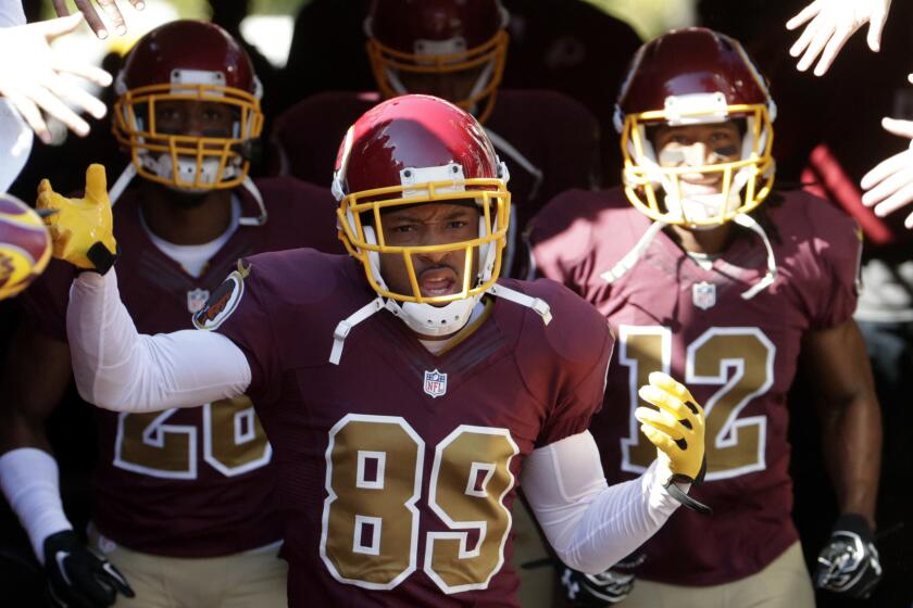 Washington Redskins wide receiver Santana Moss, center, leads his teammates onto the field before a game against the Tennessee Titans last month.