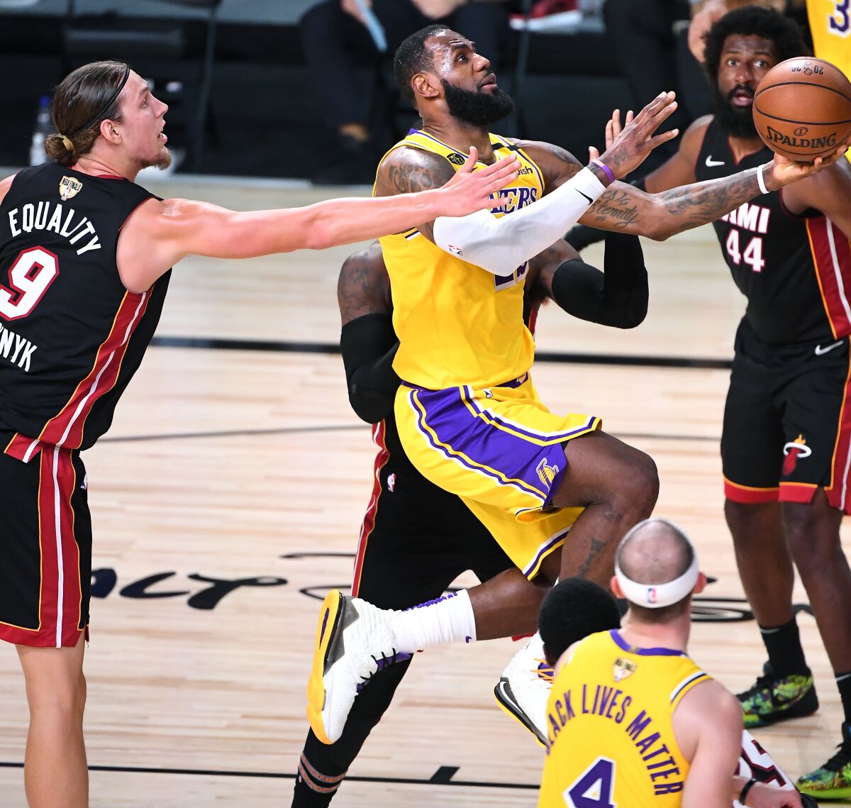 Lakers forward LeBron James drives to the basket against the Heat during Game 1.