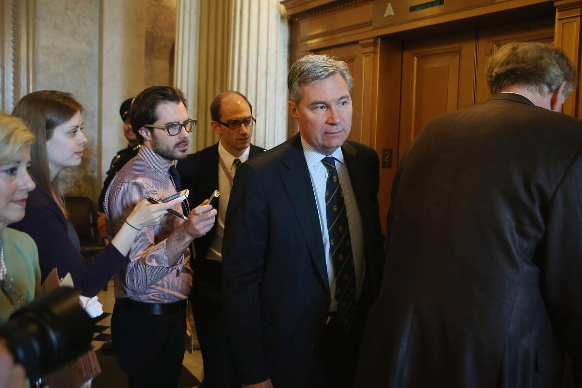 Democratic Sen. Sheldon Whitehouse of Rhode Island leads a group of reporters through the hallway after voting on a series of amendments to the Senate's proposed budget resolution for fiscal 2014 Friday evening.