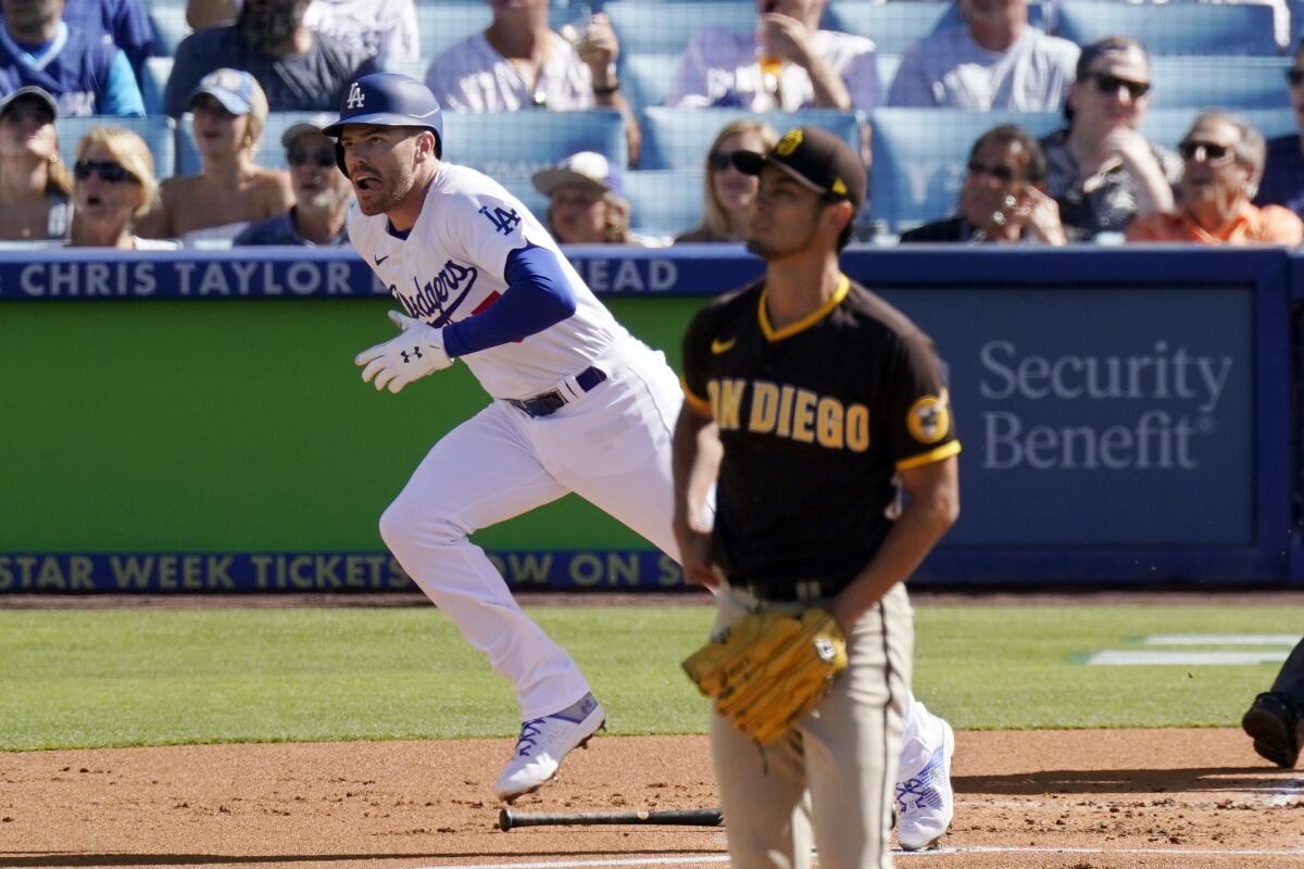 The Dodgers' Freddie Freeman and Padres starting pitcher Yu Darvish watch Freeman's first-inning home run Saturday.
