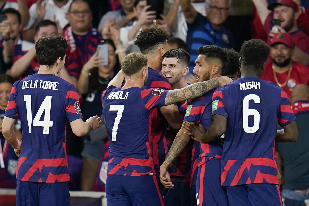 U.S. teammates celebrate with Christian Pulisic, center, after he scored a goal.