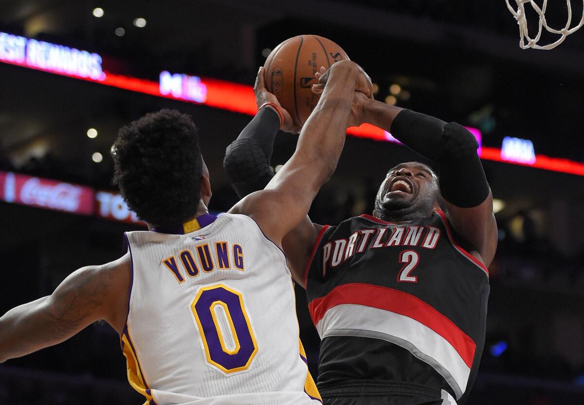 Trail Blazers guard Wesley Matthews has his shot challenged by Lakers forward Nick Young during a Jan. 11 game at Staples Center.