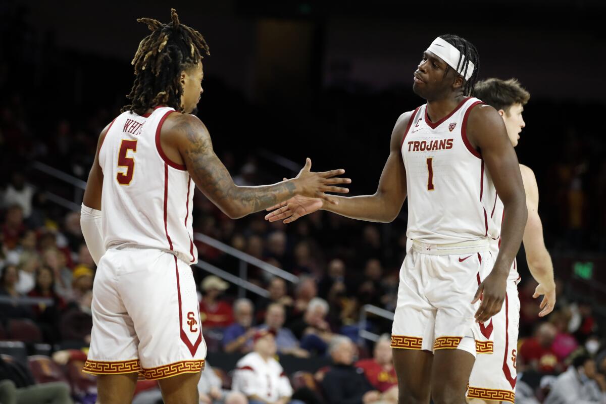 USC forward Chevez Goodwin celebrates with guard Isaiah White.