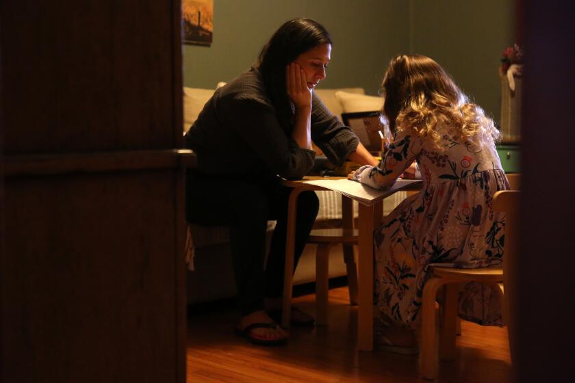 ORANGE COUNTY, CA - DECEMBER 26: Cindy Carcamo crafts with her 5-year-old daughter at home in Santa Ana on Saturday, Dec. 26, 2020 in Orange County, CA. Carcamo tried to start a pandemic pod for her daughter but the search for the right family never came to fruition. (Dania Maxwell / Los Angeles Times)