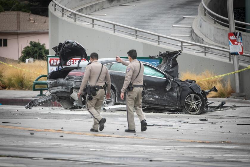 LOS ANGELES, CA - AUGUST 04: CHP and other officials investigate a fiery crash where multiple people were killed near a Windsor Hills gas station at the intersection of West Slauson and South La Brea avenues on Thursday, Aug. 4, 2022 in Los Angeles, CA. (Jason Armond / Los Angeles Times)