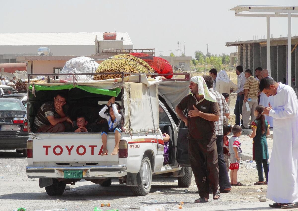 Iraqis fleeing advances by Islamic State militants in the Mosul area prepare for a journey to a safe haven in Irbil.