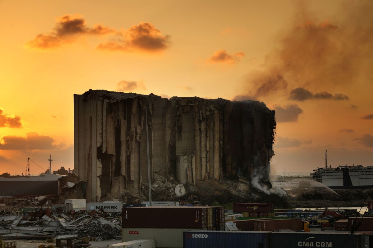 Firefighters extinguish a fire at the silos in the north block of the Beirut Port in Beirut, Lebanon, Thursday, July 21, 2022. The silos were destroyed by a massive explosion in 2020 and the structure might have caught on fire due to fermented grains. (AP Photo/Hassan Ammar)