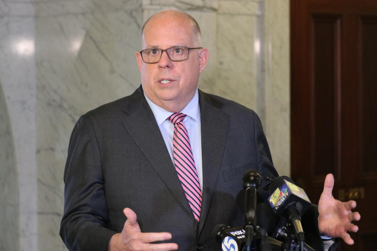 FILE - Maryland Gov. Larry Hogan talks to reporters on April, 4, 2022, in Annapolis, Md. Hogan will be called as a witness in the federal fraud trial of his former chief of staff, Roy McGrath, a rarity for a sitting governor. The trial is set to begin Oct. 24, 2022. (AP Photo/Brian Witte, File)
