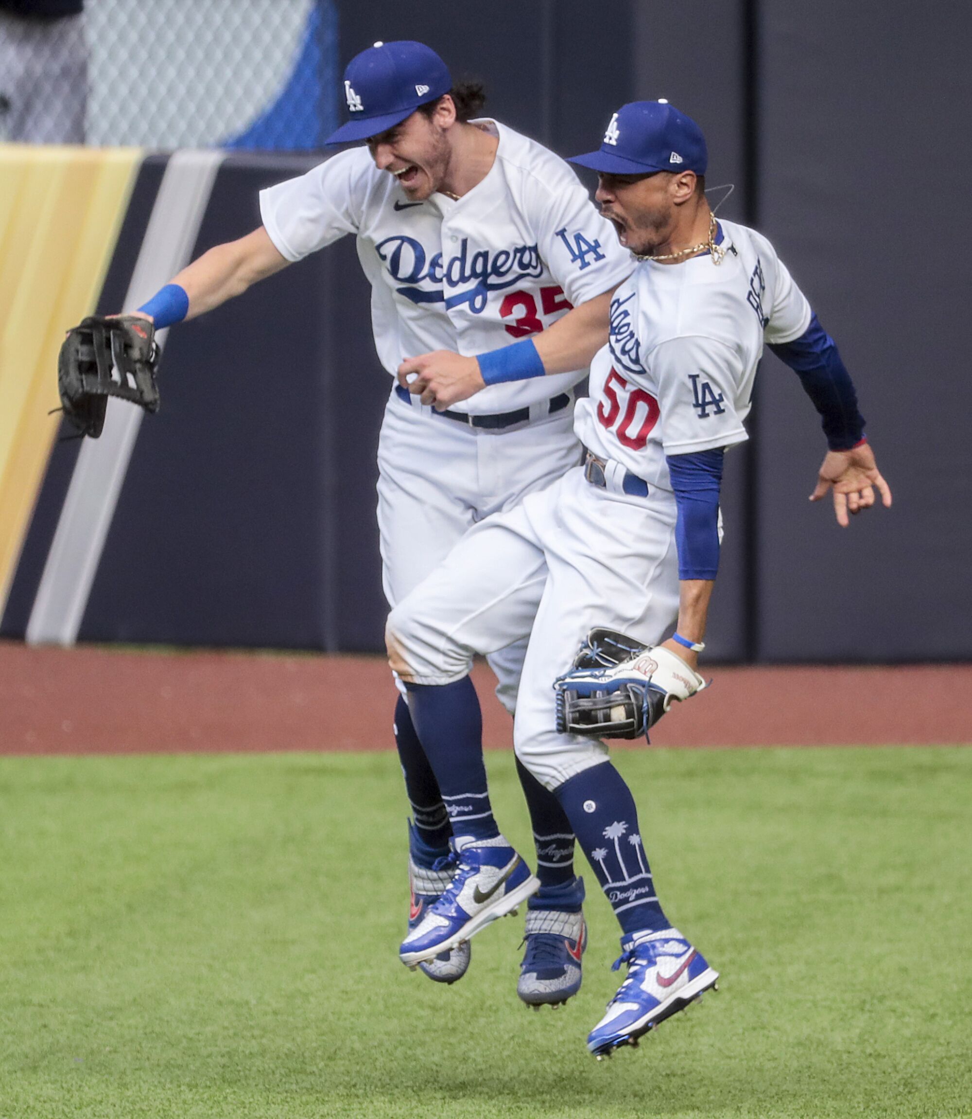 Dodgers right fielder Mookie Betts, right, celebrates with center fielder Cody Bellinger.