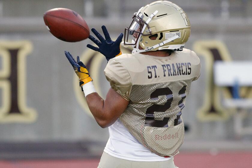 St. Francis' Kevin Armstead brings in an over-the-shoulder pass as he and his team practice plays at a preseason football practice at St. Francis High School on Thursday, August 15, 2019.