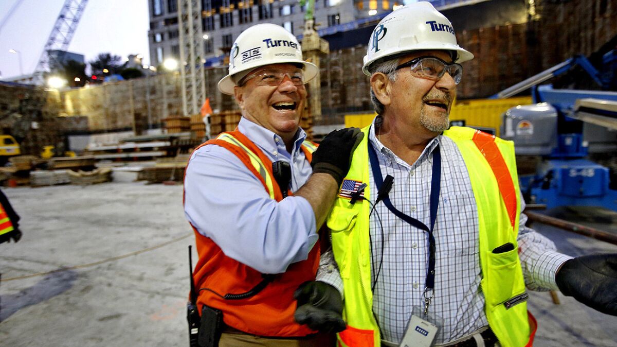 Turner Construction Co. general superintendent Michael Marchesano, left, and Bill Depasquale, field operations superintendent, stand on the 18-foot-thick foundation of the New Wilshire Grand tower.