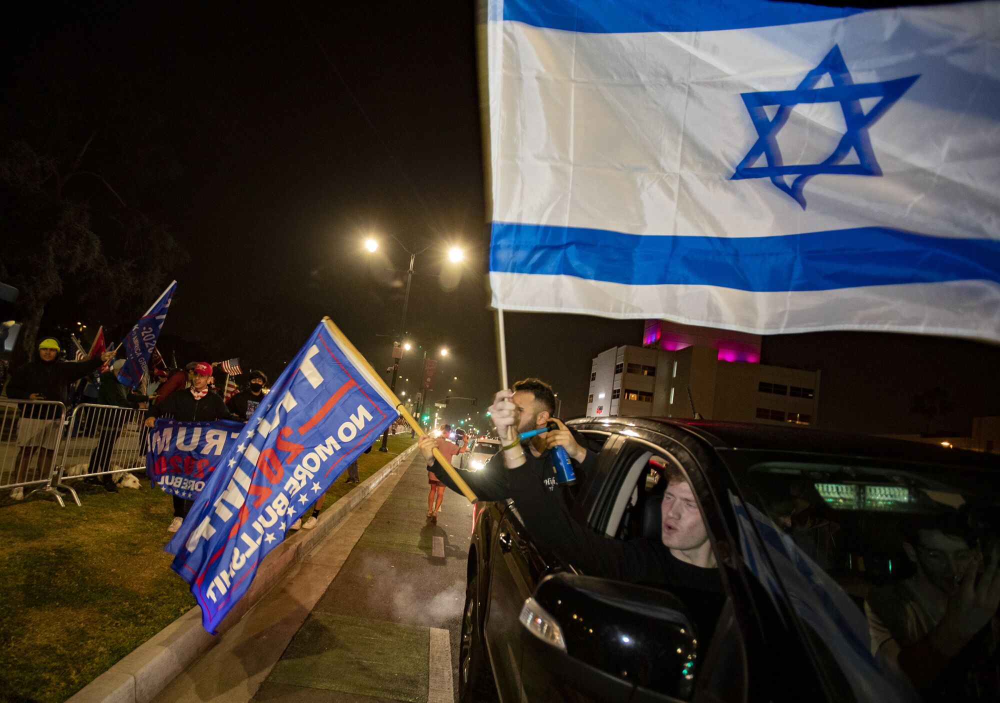 A Trump supporter holds an Israeli flag at a gathering on Santa Monica Boulevard in Beverly Hills on Tuesday.