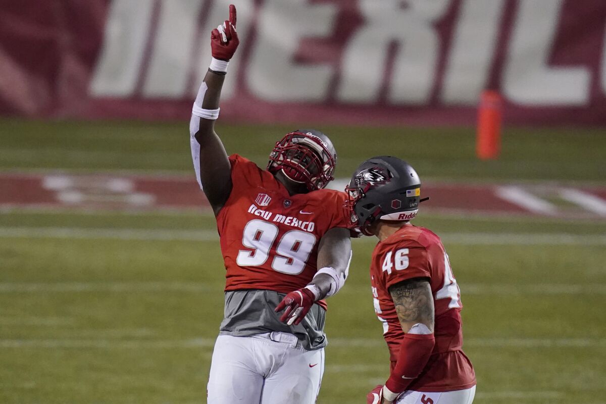 New Mexico nose tackle Ben Gansallo (99) celebrates after making a sack against Wyoming during the second half of an NCAA college football game Saturday, Dec. 5, 2020, in Las Vegas. (AP Photo/John Locher)