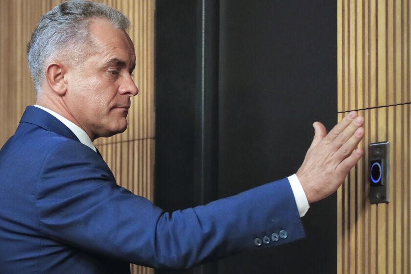 FILE- Vladimir Plahotniuc, the leader of the Democratic Party, leaves after a press statement in Chisinau, Moldova, Sunday, Feb. 24, 2019. Two Moldovan oligarchs who are implicated in a one-billion-dollar bank fraud and other illicit schemes have been added to a new U.K. sanctions list on serious corruption charges, a senior U.K. official announced Friday, Dec. 9, 2022. (AP Photo/Vadim Ghirda, File)