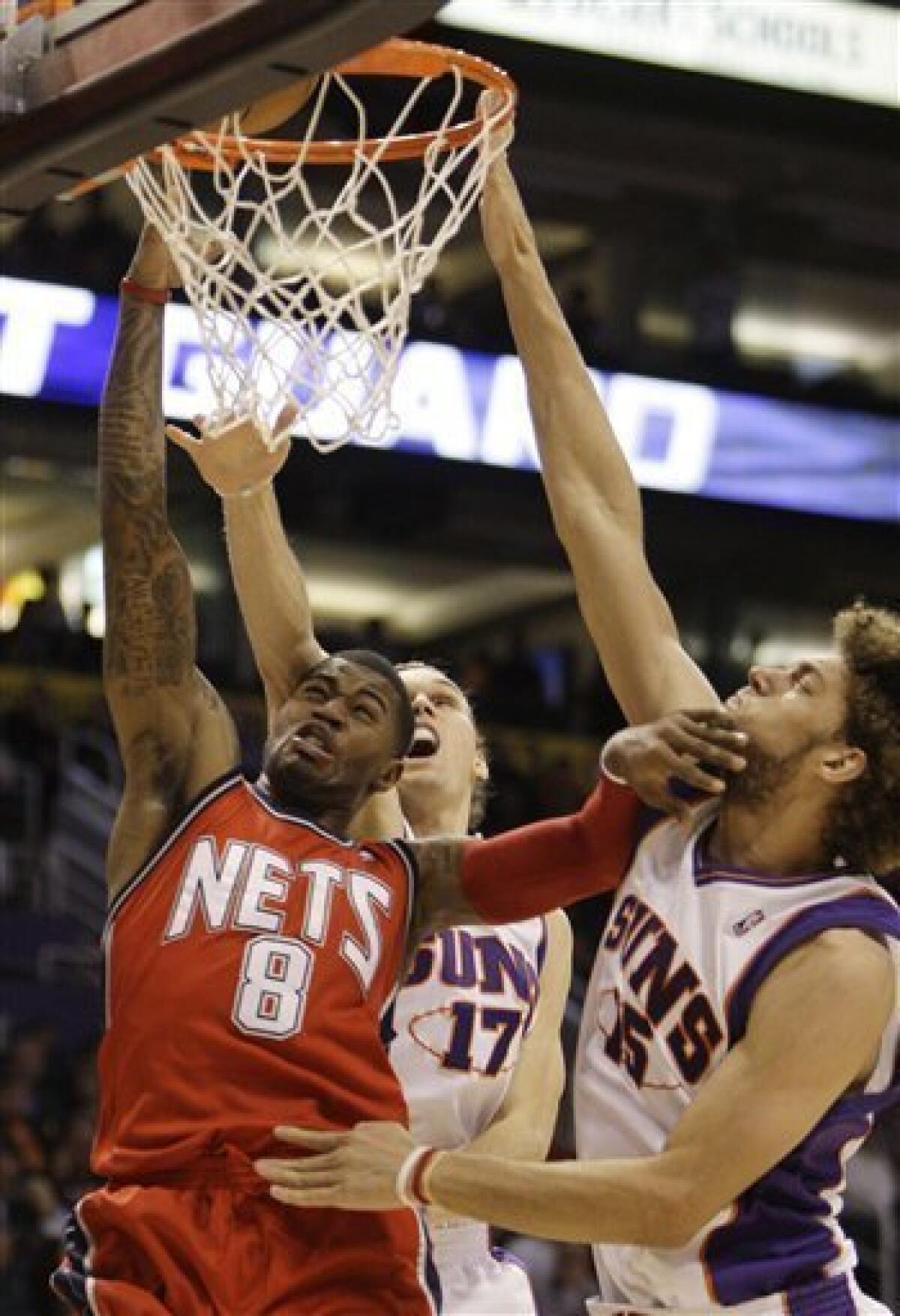 Yi Jianlian and Brook Lopez of the New Jersey Nets look on during