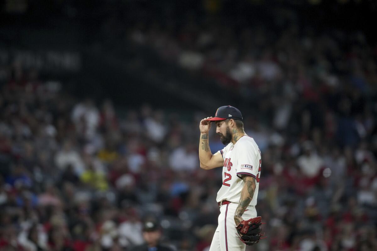 Angels relief pitcher Hans Crouse adjusts his hat during the sixth inning against the Oakland Athletics