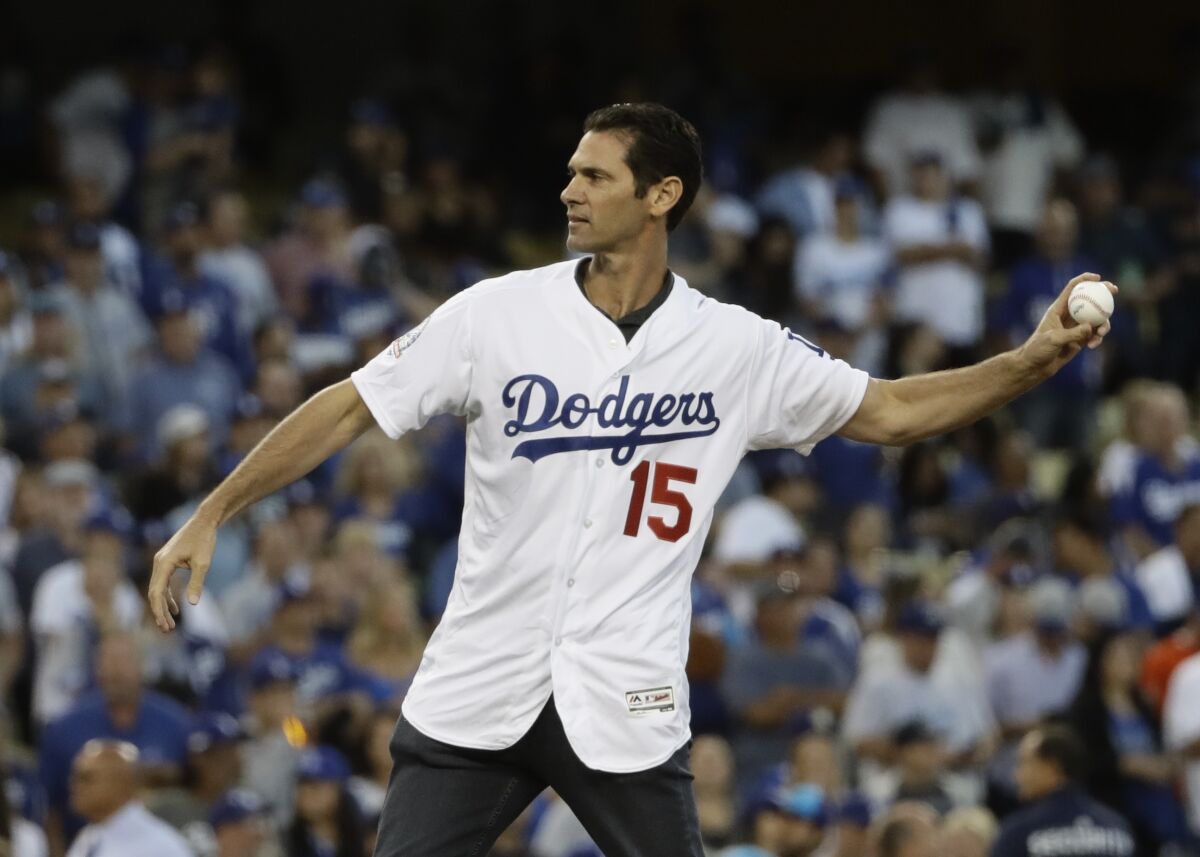 Former Dodgers slugger Shawn Green throws the first pitch before Game 4 of the NLCS on Oct. 16, 2018.