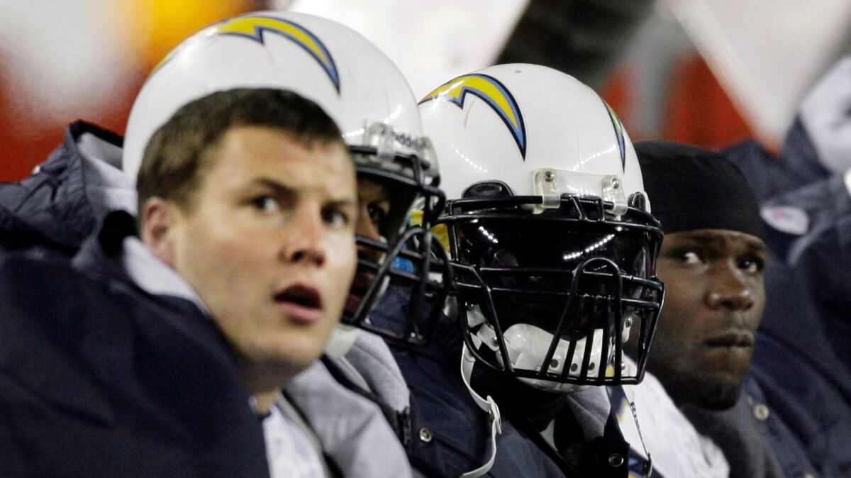 San Diego Chargers quarterback Philip Rivers, left, running back LaDainian Tomlinson, second from right, and fullback Andrew Pinnock, right, sit on the bench during the third quarter of the 2007 AFC Championship game.