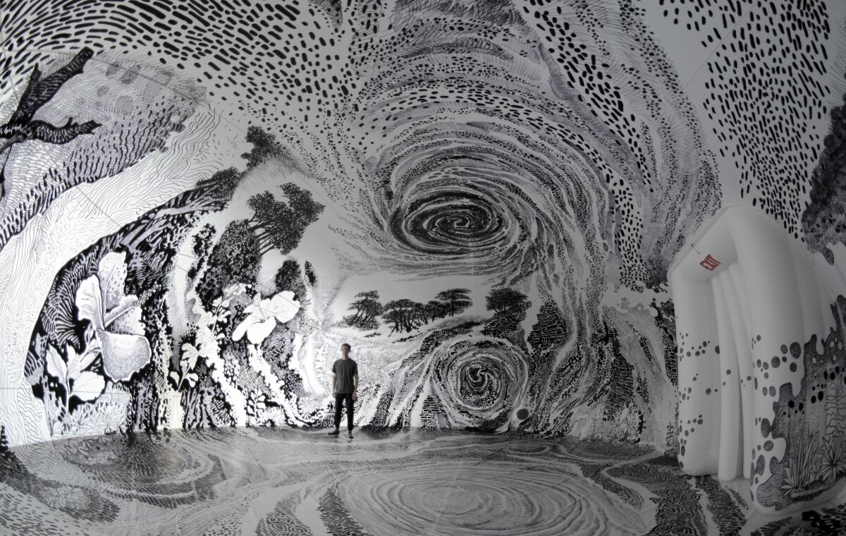 Artist Oscar Oiwa stands inside his immersive, inflatable installation "Dreams of a Sleeping World" at the USC Pacific Asia Museum in Pasadena. 
