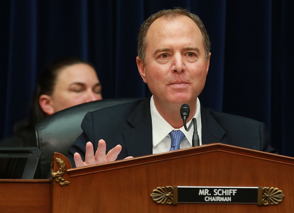 Adam Schiff speaking into a microphone from a dais behind a nameplate reading "Mister Schiff, Chairman."