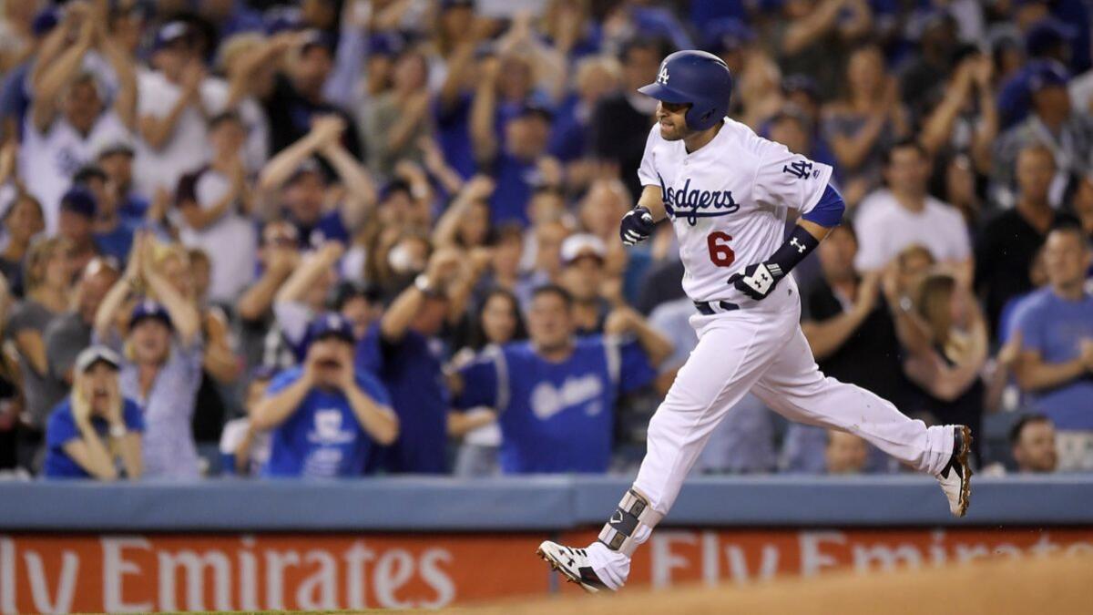 Dodgers' Brian Dozier rounds third after hitting a solo home run during the fifth inning against the Milwaukee Brewers on Wednesday.