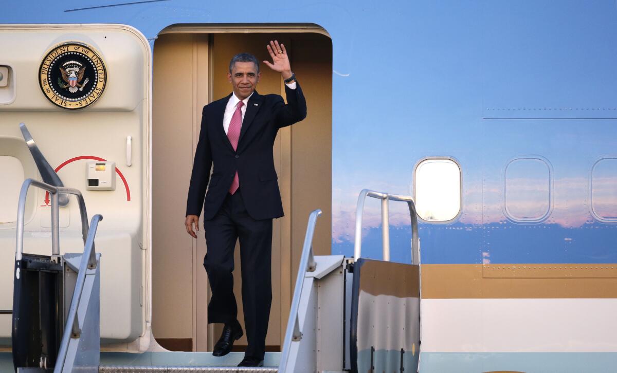 President Obama waves on his arrival at Seattle-Tacoma International Airport.