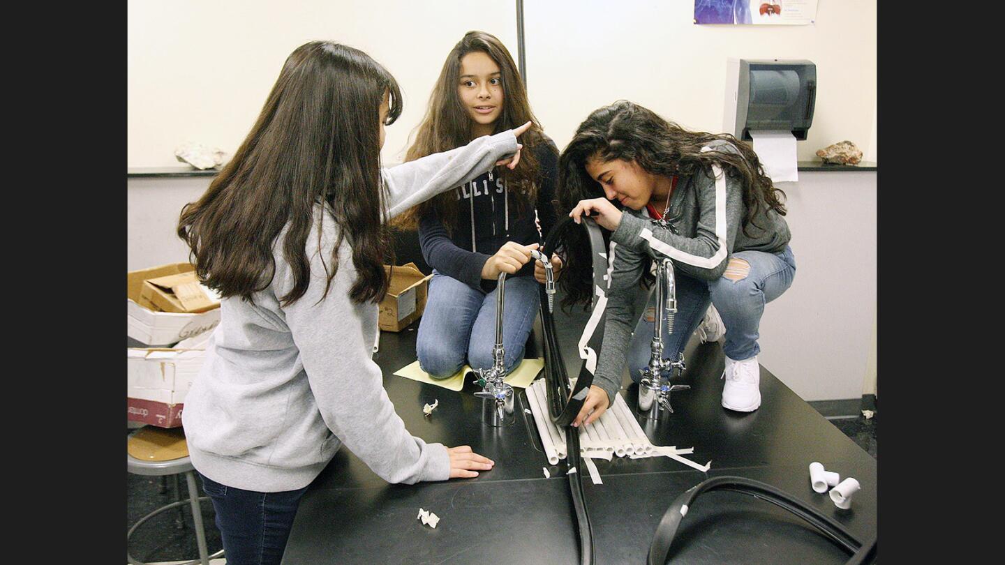 Photo Gallery: 8th grade Theodore Roosevelt Middle School students make roller coasters in physical science class
