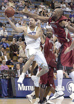 UCLA's Jordon Farmar scores under the defense of New Mexico State Trevor Lawrence in the second half.