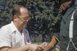 In this 1950's file photo released by the National Archives, a black man included in a syphilis study has blood drawn by a doctor in Tuskegee, Ala. Most Black Americans are likeliest to say that they experience racial discrimination regularly and that such experiences inform how they view major U.S. institutions, according to a new study from the Pew Research Center released Monday, June 10, 2024. The study seeks to highlight the country's documented racist history against Black people as a possible explanation for why Black Americans hold conspiratorial views about major U.S. institutions. (National Archives via AP)