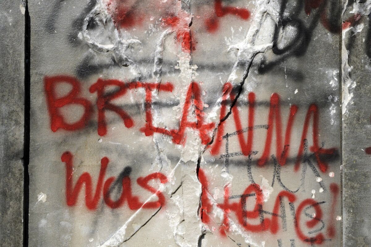 Graffiti runs across the base of a 50-foot-tall obelisk that stood as a Confederate monument in Birmingham, Ala.