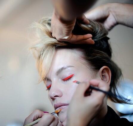 A model gets a dash of neon eyeliner before Gwen Stefani's L.A.M.B. Spring 2010 fashion presentation.