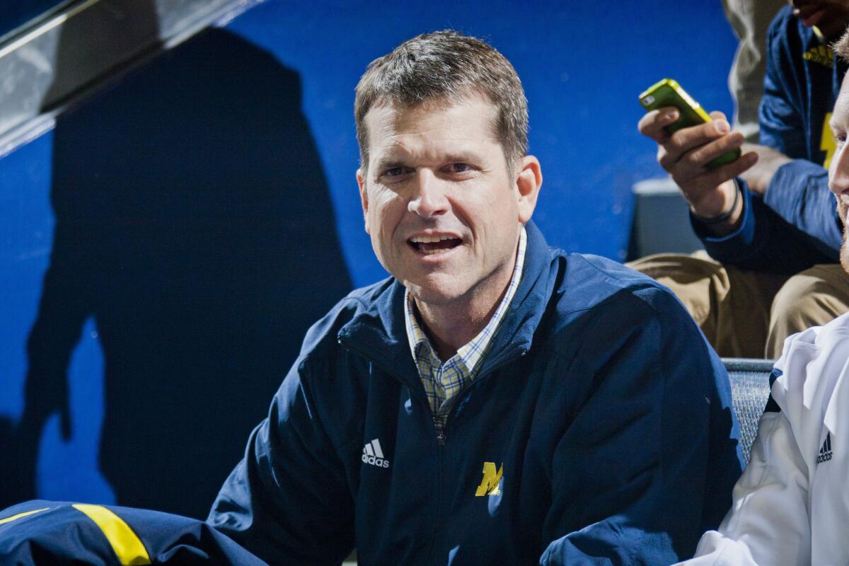 Michigan Coach Jim Harbaugh attends a Wolverine basketball game on Jan. 17.
