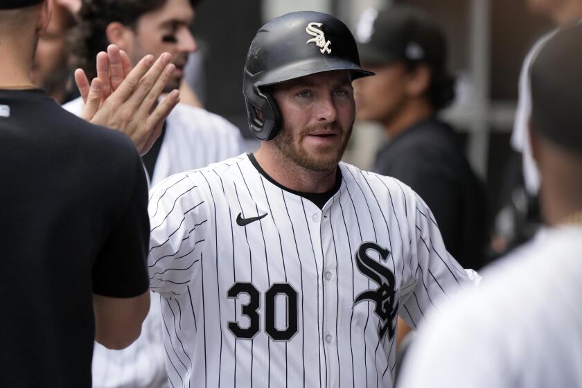 Chicago White Sox's Robbie Grossman celebrates with teammates after scoring on an RBI double by Tommy Pham during the first inning of a baseball game against the Minnesota Twins in Chicago, Wednesday, May 1, 2024. (AP Photo/Nam Y. Huh)