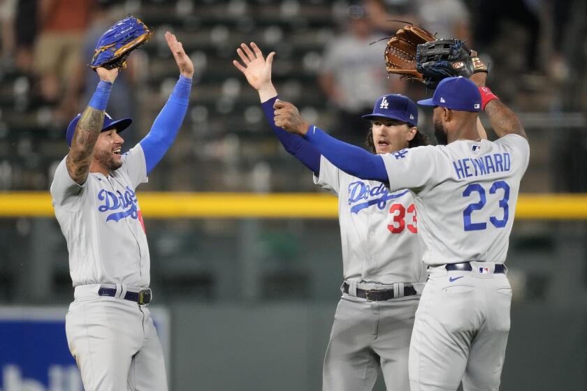 From left, Dodgers' David Peralta,  James Outman and Jason Heyward celebrate a win over the Rockies on Sept. 27, 2023.