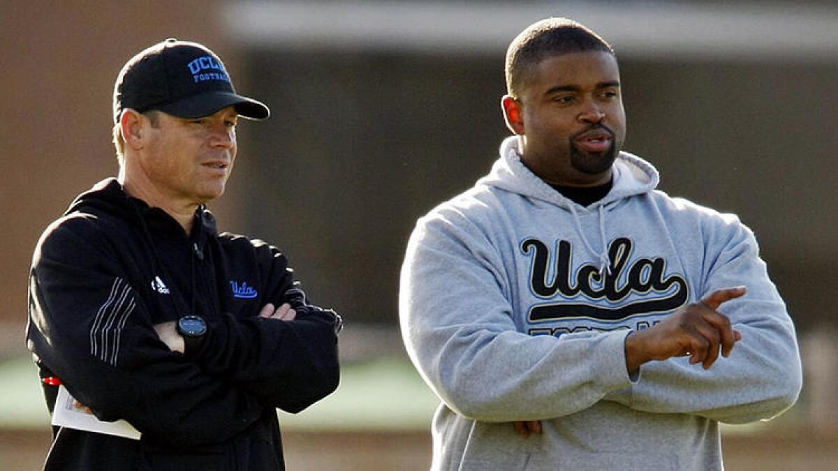 UCLA offensive line coach Adrian Klemm, right, stands with Coach Jim Mora at practice on April 1, 2014.