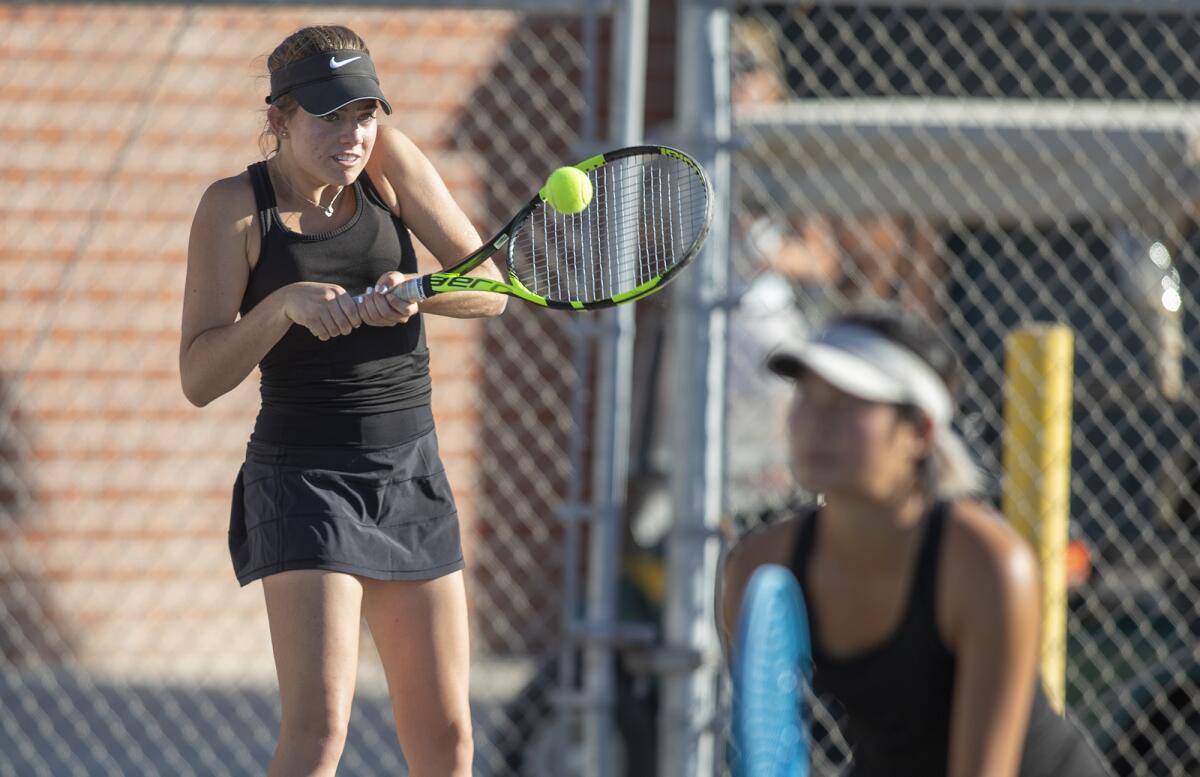 Huntington Beach's Haley Forth, left, returns a shot as partner Alissa Wong looks on in a Wave League match at Edison on Thursday.