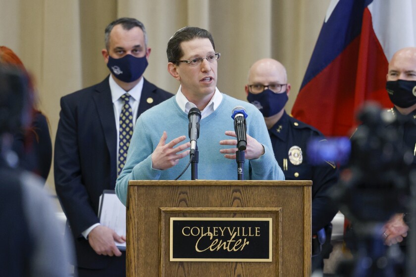 Rabbi Charlie Cytron-Walker of Congregation Beth Israel addresses reporters during a news conference at Colleyville Center on Friday, Jan. 21, 2022 in Colleyville, Texas. In the final moments of a 10-hour standoff with a gunman at a Texas synagogue, the remaining hostages and officials trying to negotiate their release took “near simultaneous plans of action,” with the hostages escaping as an FBI tactical team moved in, an official said Friday. (Elias Valverde II/The Dallas Morning News via AP)