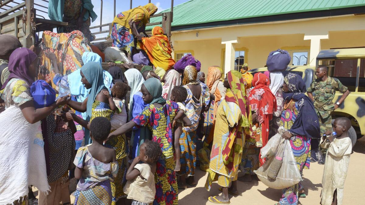 Women and children rescued by Nigerian soldiers from Boko Haram extremists in the northeast of Nigeria arrive Friday at a military office in Maiduguri.