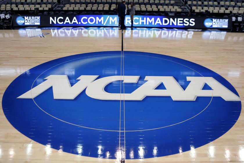 FILE - In this March 18, 2015, file photo, the NCAA logo is displayed at center court as work continues at The Consol Energy Center in Pittsburgh, for the NCAA college basketball tournament. The NCAA has fallen short of upholding its commitment to gender equity spending more on male athletes on average than female ones according a second review. A law firm hired by the NCAA to investigate equity issues released a 153-page report Tuesday night, Oct. 26, 2021 that includes a series of recommendations to improve the gap. (AP Photo/Keith Srakocic, File)