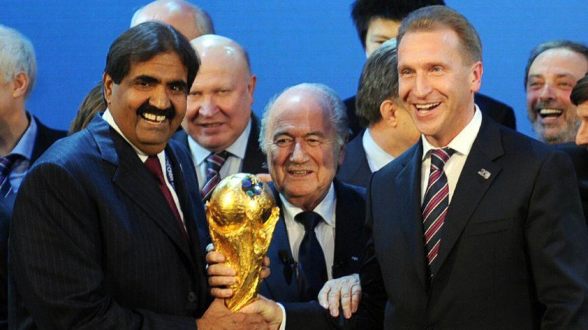 Qatar Football Assn. President Sheikh Hamad bin Khalifa Al-Thani, left, FIFA President Sepp Blatter, center, and Russia Deputy Prime Minister Igor Shuvalov pose with the World Cup trophy after Russia and Qatar were named the 2018 and 2022 World Cup hosts, respectively, in December 2010.