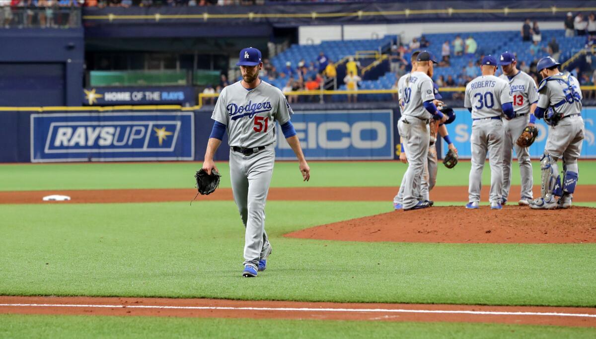 Dodgers pitcher Dylan Floro (51) walks off after being removed in the seventh inning against the Tampa Bay Rays on Wednesday in St. Petersburg, Fla.