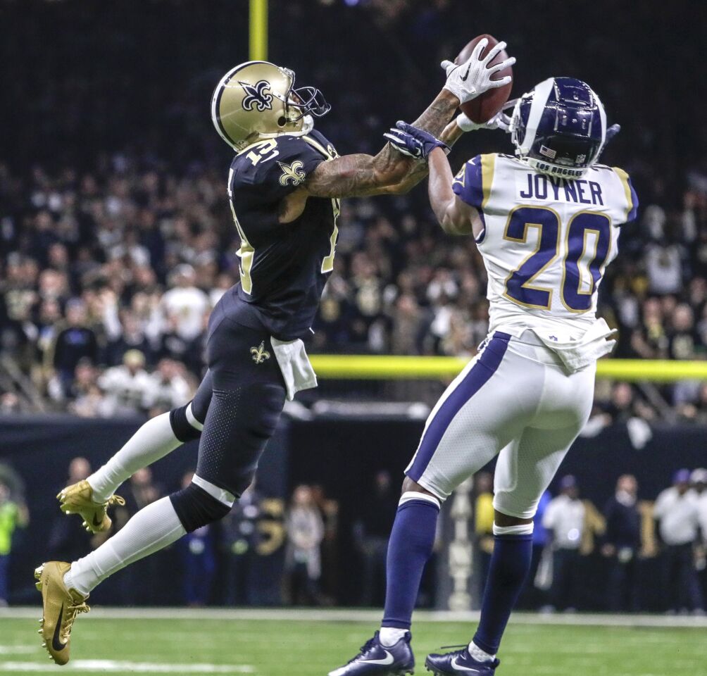 New Orleans Saints receiver Ted Ginn Jr. pulls down a 43-yard pass in front of Rams safety Lamarcus Joyner late in the fourth quarter in the NFC Championship at the Superdome.