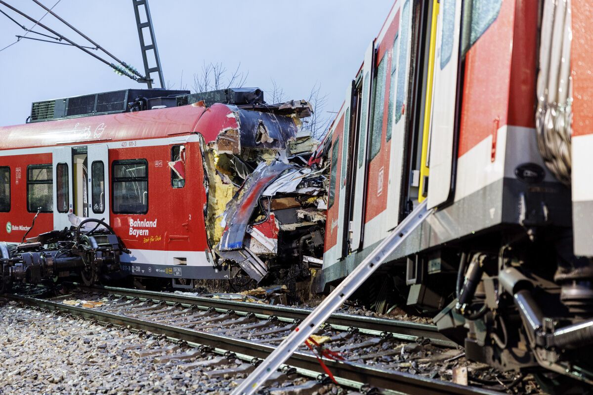 The two damaged S-Bahn trains are seen at the scene of the accident a day after a collision in Schaeftlarn, Germany, Tuesday, Feb. 15, 2022. German police say several people have been injured and at least one person has died in a collision on Monday, Feb. 14, 2022, between two commuter trains near Munich. (Matthias Balk/dpa via AP)
