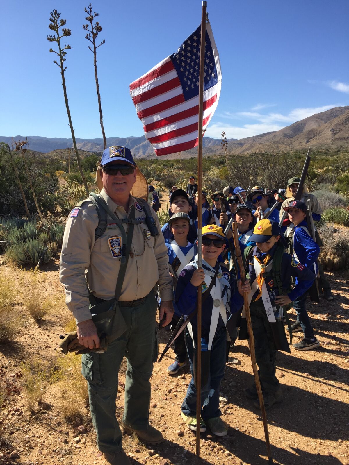 Scoutmaster Duane Neyens, left, leads more than 30 Cub Scouts on a five-mile hike to earn the Mormon Battalion Trail High Adventure Award near Julian on Oct. 19.