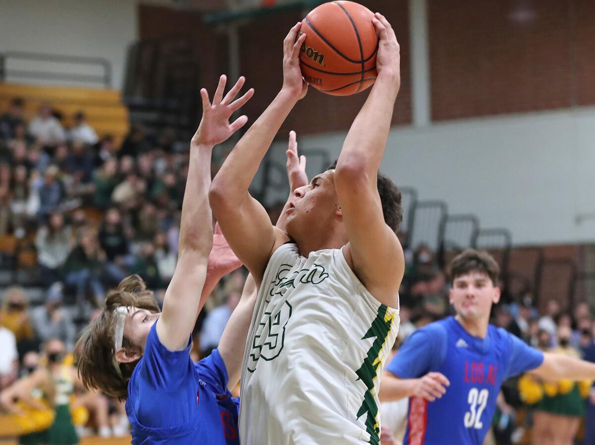 Edison's Trey Wilborn (33) takes an interior pass and turns to the basket for two points against Los Alamitos on Feb. 3.