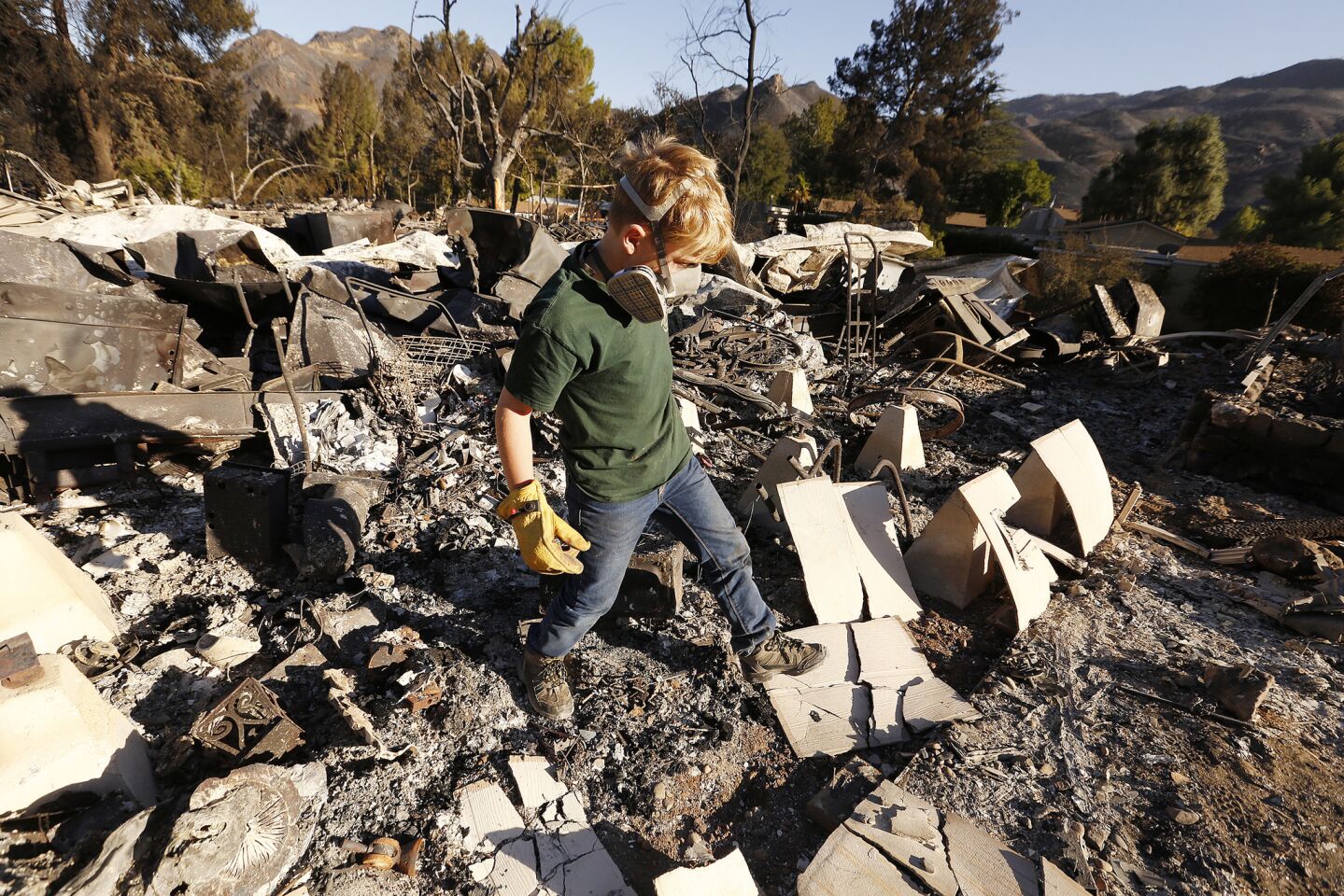 9-year-old Landon Quirk came with his father Trevor Quirk to help search through the rubble of a friend's home in the Seminole Springs mobile home on Mulholland Drive in Agoura Hills.