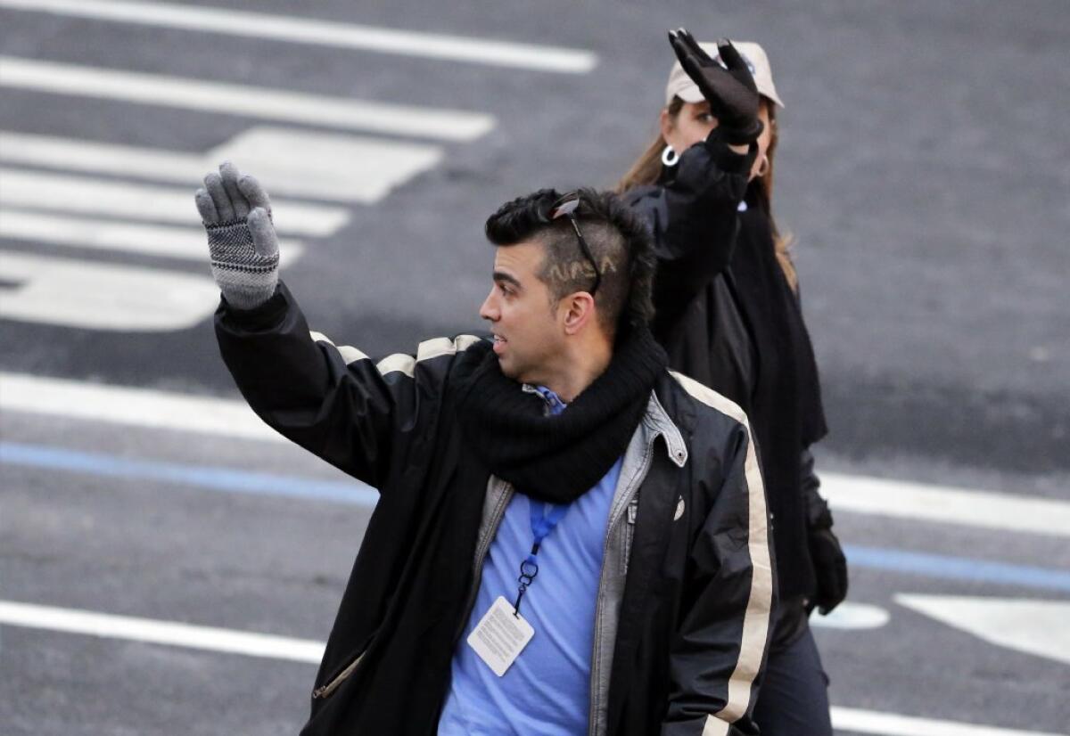'Mohawk Guy' Bobak Ferdowsi, with "NASA" carved into his hair, walks in last month's presidential inaugural parade on Pennsylvania Avenue last month. Ferdowsi says he's got a brand new hairstyle for President Obama's State of the Union address Tuesday night.