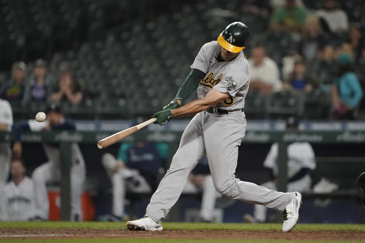 Oakland Athletics' Matt Olson hits a two-run single during the seventh inning of the team's baseball game against the Seattle Mariners, Tuesday, June 1, 2021, in Seattle. (AP Photo/Ted S. Warren)