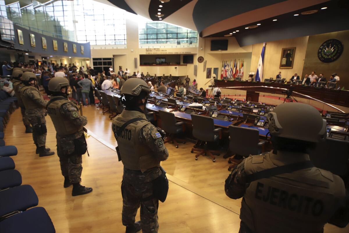Salvadoran soldiers enter a congressional building upon the arrival of lawmakers in San Salvador on Sunday. Top commanders of the country's police and military have expressed allegiance to President Nayib Bukele during a standoff with the opposition-controlled legislature over a loan.
